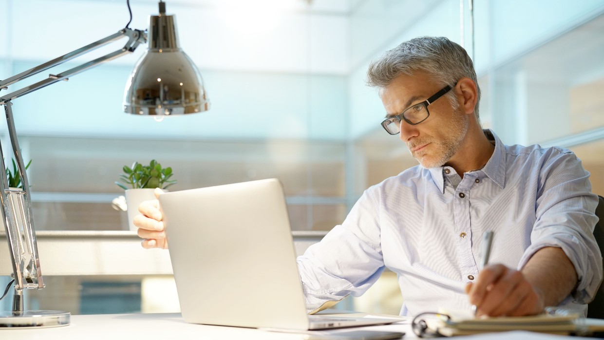 CEO of a construction business working on a laptop