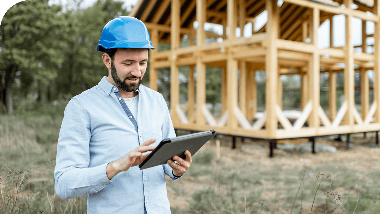 A construction quantity surveyor reviewing project costs on a tablet
