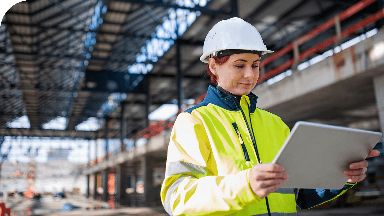 A female project manager booking equipment for her construction site on a tablet