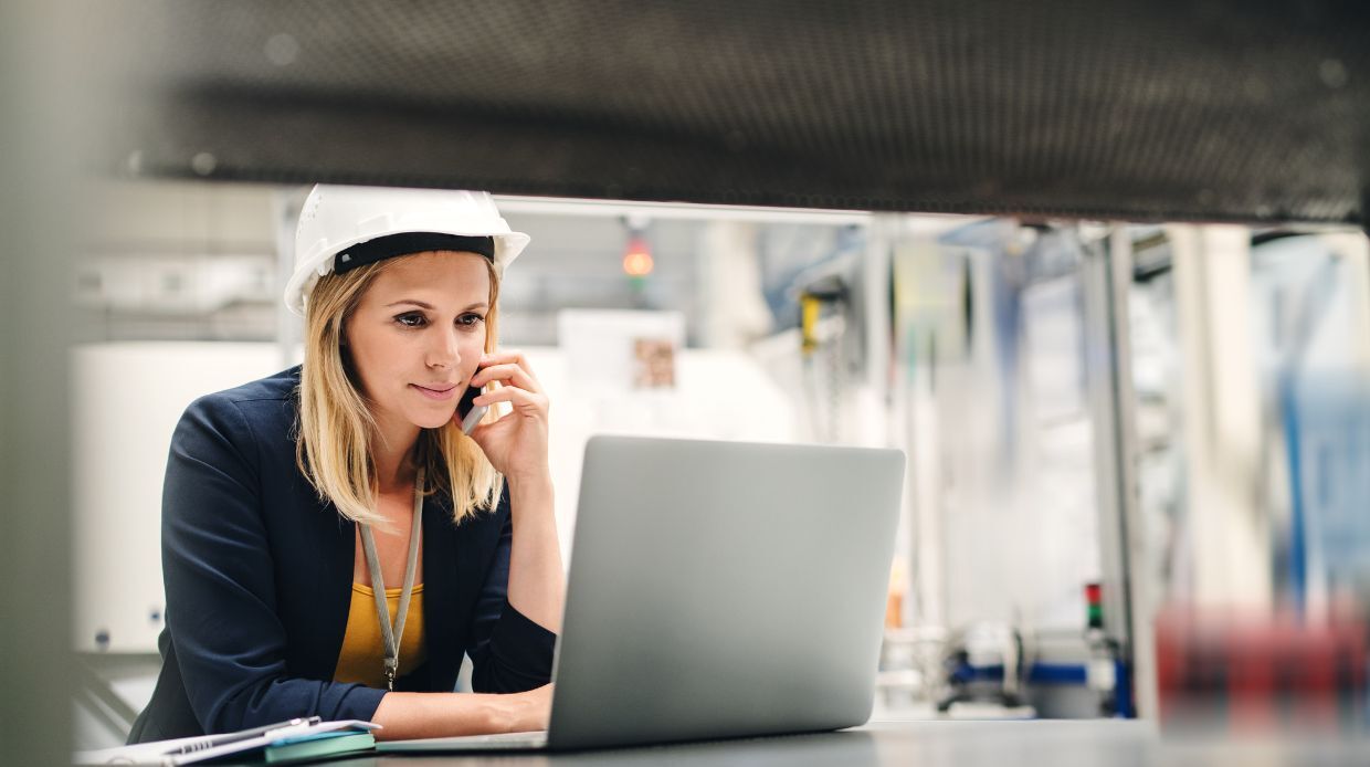 Lady at a laptop wearing a hardhat